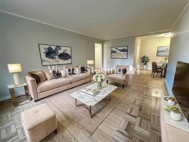 living room with ornamental molding and baseboards