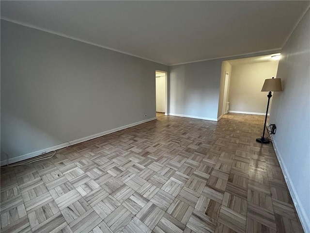 unfurnished room with baseboards