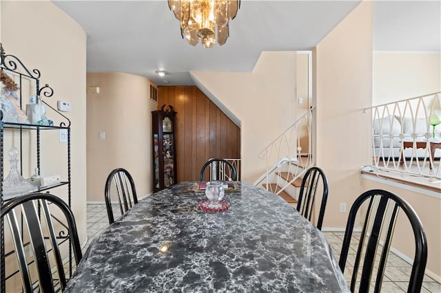 dining space with baseboards and a chandelier