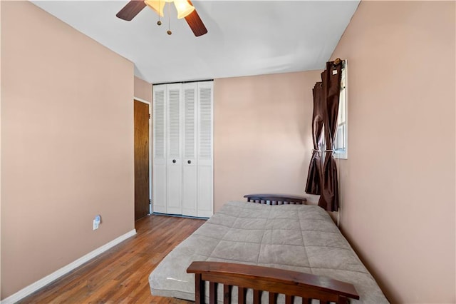 bedroom featuring ceiling fan, a closet, and light wood-type flooring