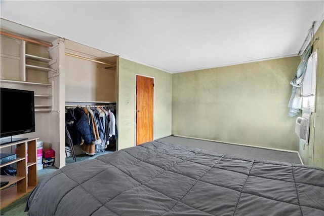 bedroom featuring a closet and a wall mounted AC