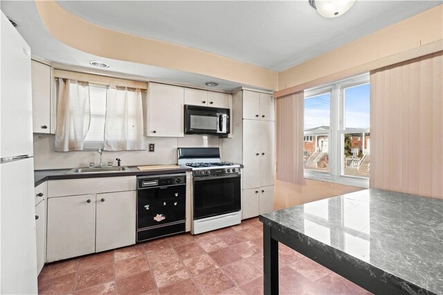 kitchen with white cabinetry, sink, and black appliances