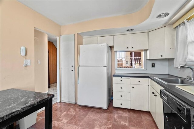 kitchen featuring white cabinetry, black dishwasher, sink, and white fridge