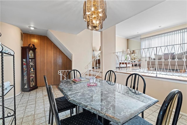 dining area with stairway and a chandelier