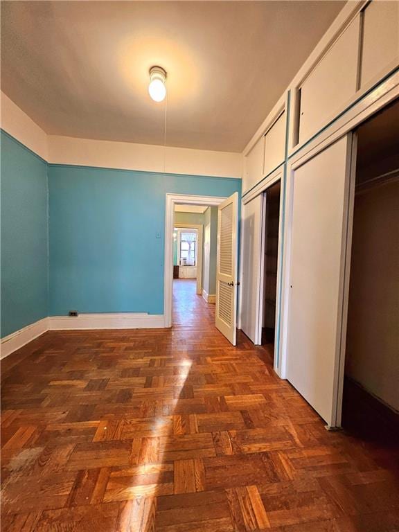 hallway with dark parquet flooring