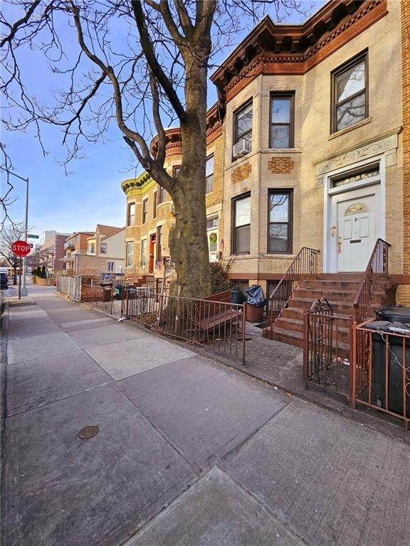 view of property with a residential view and fence