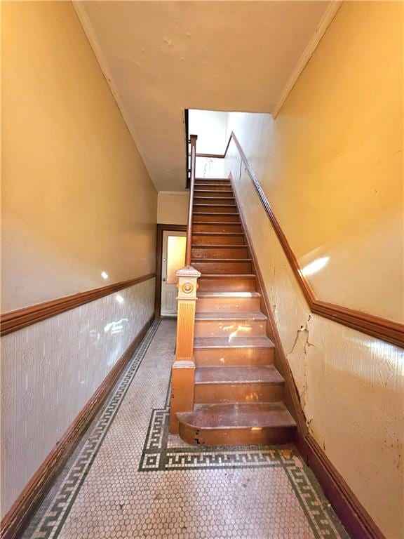 staircase featuring ornamental molding