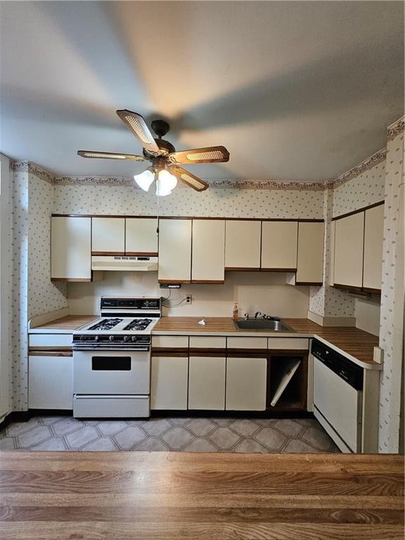 kitchen featuring sink, white gas range oven, dishwasher, and ceiling fan