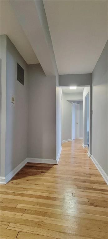 corridor with light hardwood / wood-style flooring