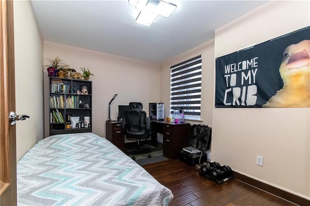 bedroom with dark wood-style flooring and baseboards