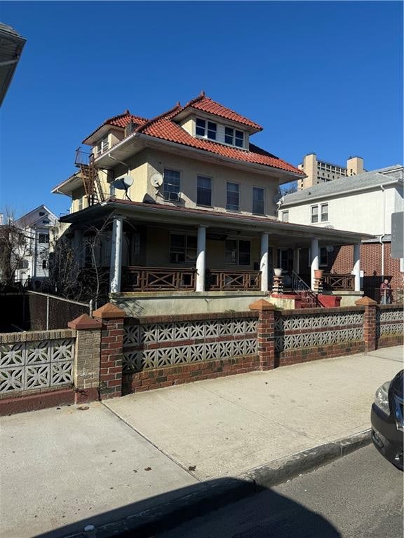 mediterranean / spanish house featuring covered porch