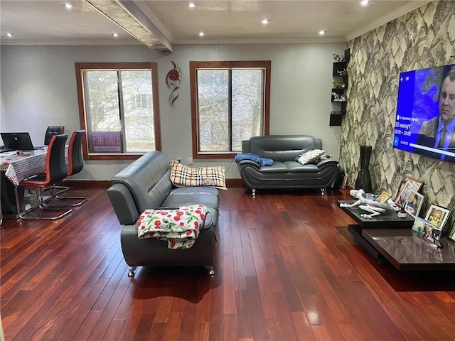 living room with hardwood / wood-style flooring, ornamental molding, and a healthy amount of sunlight