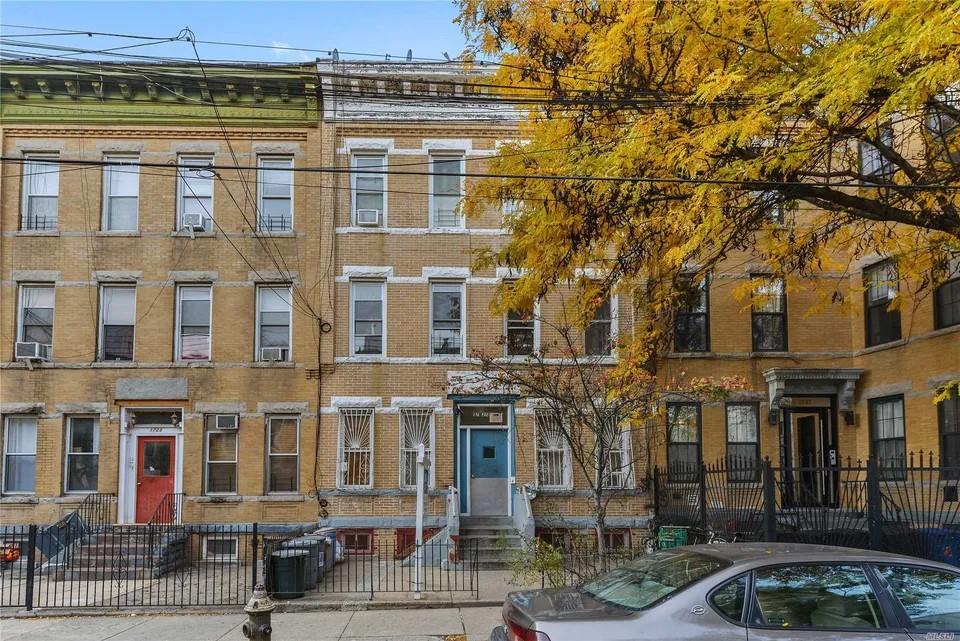 1725 Menahan St, Queens, NY 11385 - townhome / multi-family property featuring cooling unit, fence private yard, entry steps, and brick siding