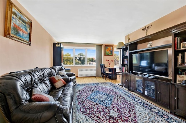 living room with radiator and light hardwood / wood-style floors