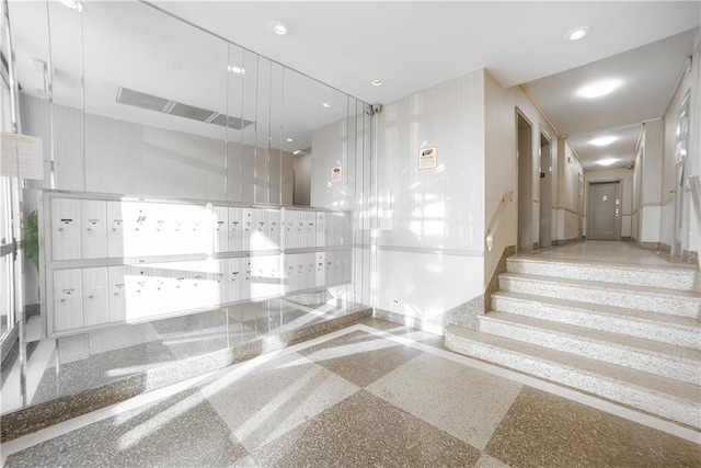 stairway featuring recessed lighting, mail area, and baseboards