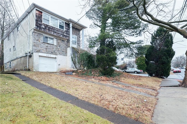 view of home's exterior with a yard and a garage