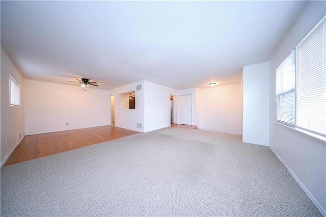 spare room with light carpet and ceiling fan