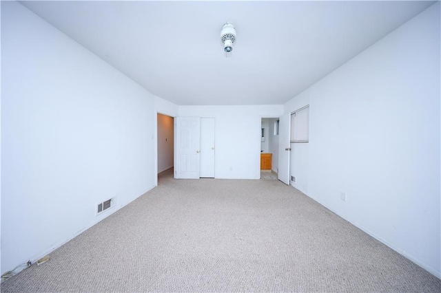 unfurnished bedroom featuring light colored carpet