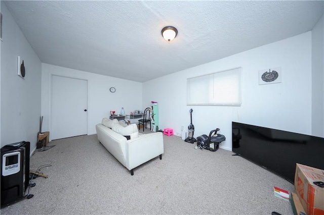 carpeted living room featuring a textured ceiling