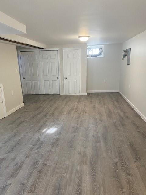 298 Bay 14th St, Brooklyn, NY 11214 - unfurnished bedroom with wood finished floors and baseboards