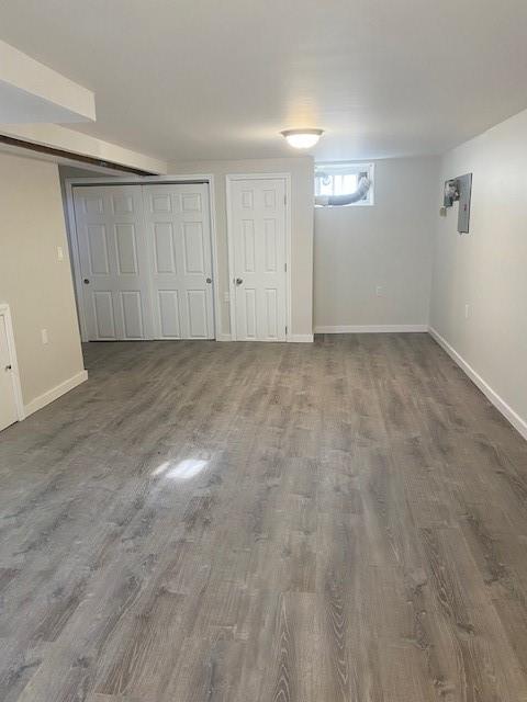 basement featuring dark wood-style floors and baseboards