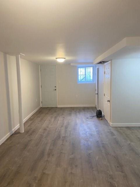 below grade area featuring baseboards and dark wood-style flooring