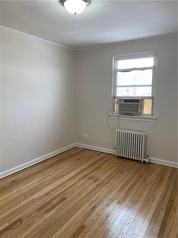 298 Bay 14th St, Brooklyn, NY 11214 - unfurnished room with radiator heating unit, crown molding, hardwood / wood-style flooring, and baseboards