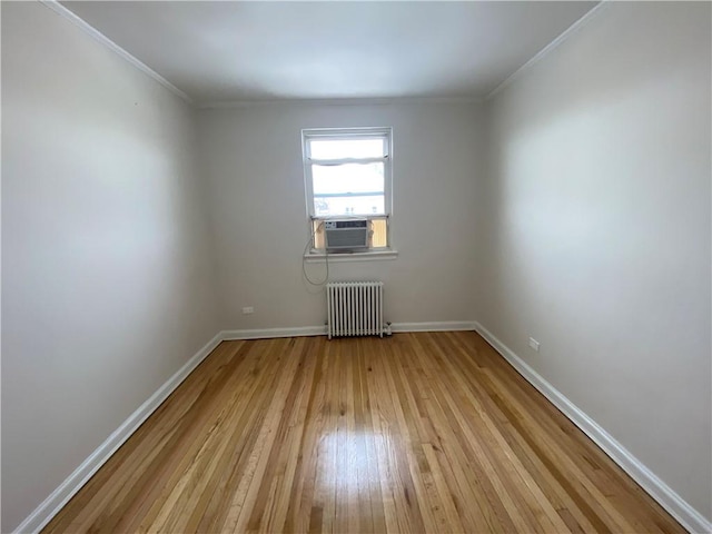 298 Bay 14th St, Brooklyn, NY 11214 - empty room featuring radiator heating unit, light wood-style floors, baseboards, ornamental molding, and cooling unit