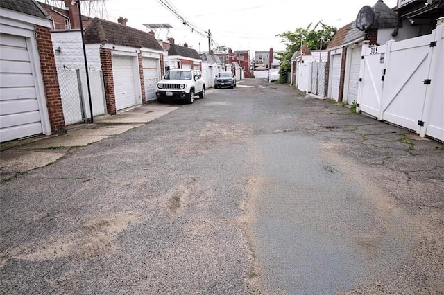 298 Bay 14th St, Brooklyn, NY 11214 - view of asphalt alley featuring a residential view, community garages, and a gate