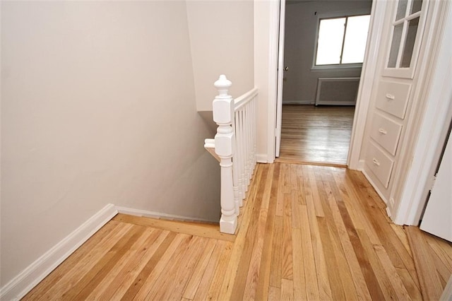 298 Bay 14th St, Brooklyn, NY 11214 - corridor featuring an upstairs landing, light wood finished floors, and radiator