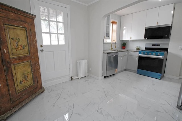 298 Bay 14th St, Brooklyn, NY 11214 - kitchen with radiator heating unit, appliances with stainless steel finishes, arched walkways, white cabinets, and light marble finish floors
