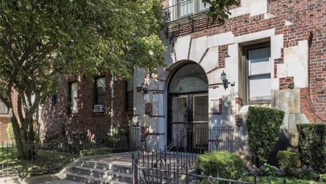 property entrance with brick siding