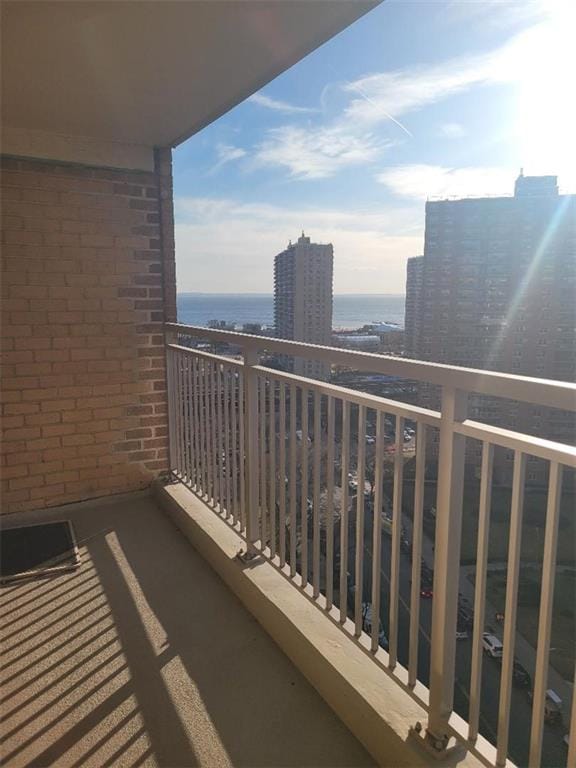 balcony featuring a view of city and a water view