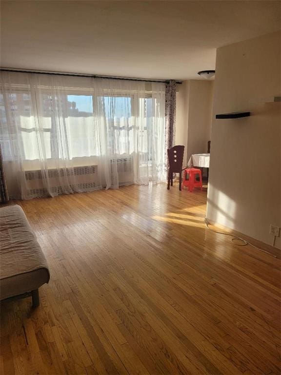 2935 W 5th St Unit 16E, Brooklyn, NY 11224 - living area with radiator and wood finished floors