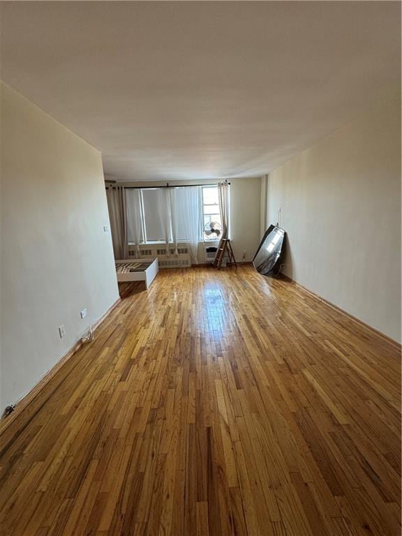 unfurnished living room featuring hardwood / wood-style floors