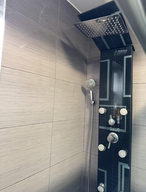 interior space featuring a tile shower