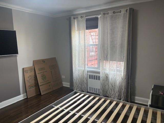 unfurnished bedroom featuring radiator, baseboards, and ornamental molding