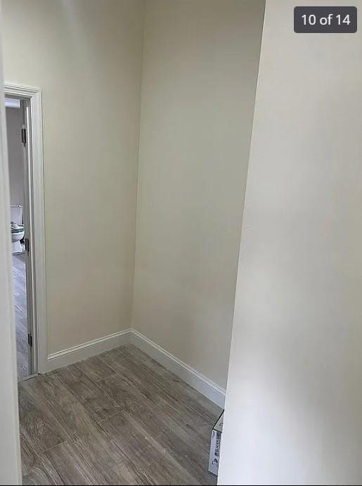 hallway with hardwood / wood-style floors