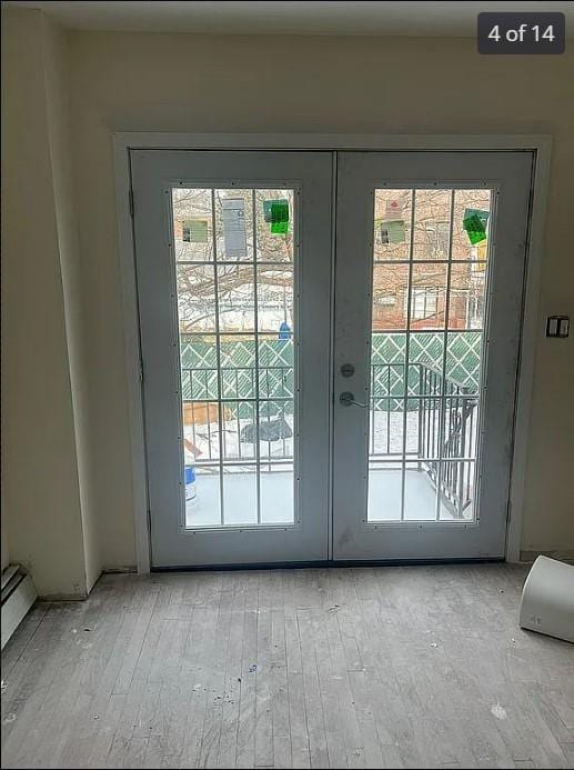 doorway featuring french doors, a healthy amount of sunlight, and light hardwood / wood-style floors