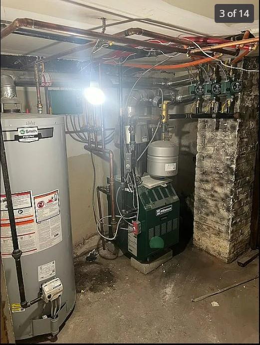 utility room with gas water heater