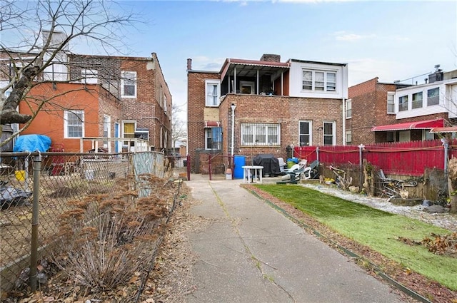 back of property featuring fence and brick siding