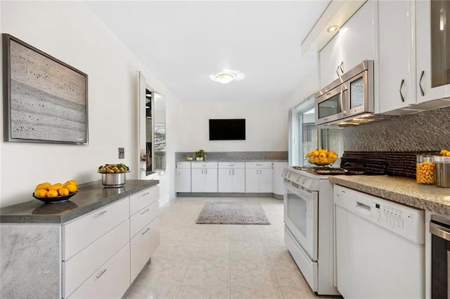 42 Narrows Rd S Unit 1, Staten Island, NY 10305 - kitchen with white appliances, decorative backsplash, white cabinets, and light tile patterned floors