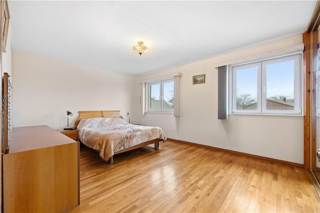 bedroom featuring baseboards and light wood-type flooring