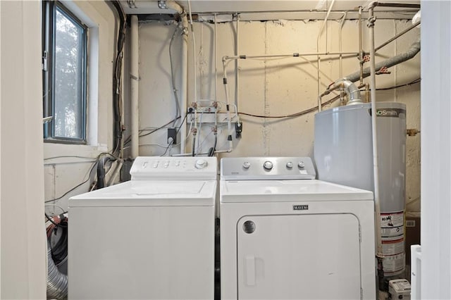 clothes washing area featuring water heater, laundry area, and washing machine and dryer