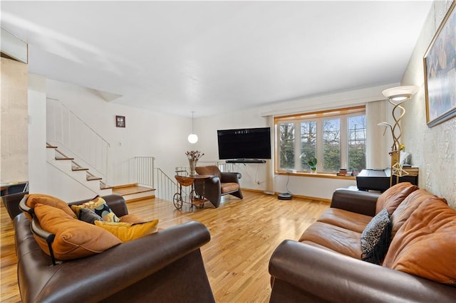 living room with stairs and wood finished floors