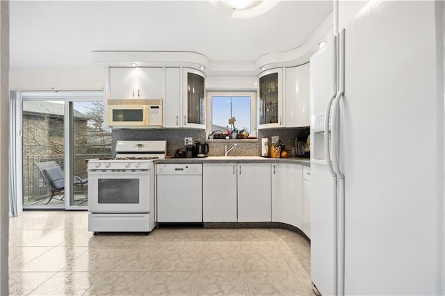 kitchen with white cabinetry, white appliances, and backsplash