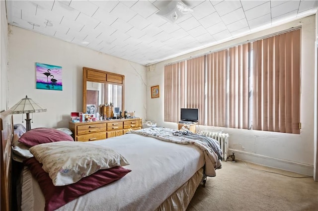 carpeted bedroom with radiator