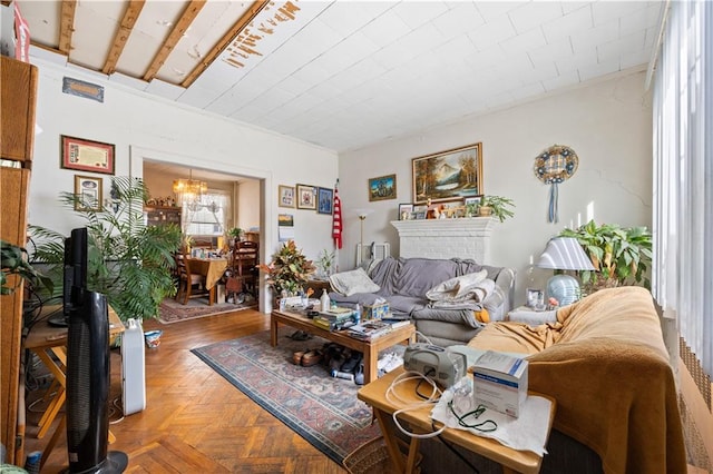 living area with a chandelier and a brick fireplace