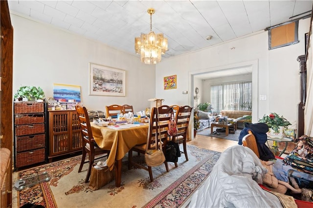 dining room featuring hardwood / wood-style flooring and a notable chandelier