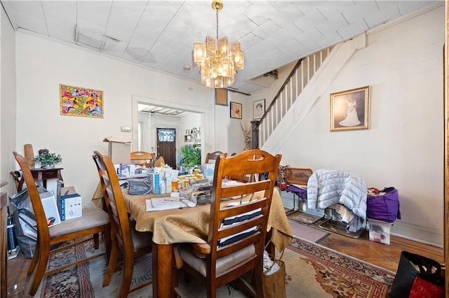 dining space featuring hardwood / wood-style floors and a chandelier